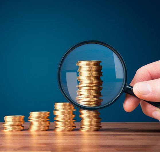 Coins examined with magnifying glass