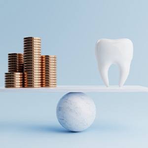 Illustration of tooth balanced against stacks of coins