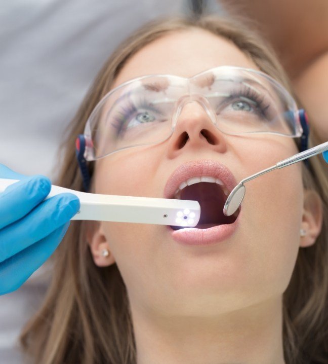 Dentist capturing smile images using intraoral camera