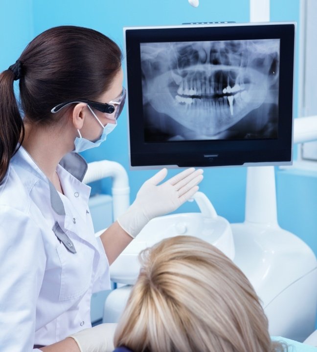 Dentist and dental patient looking at all digital x-rays