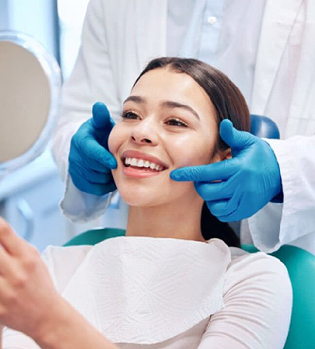 a patient smiling after receiving care from her aetna