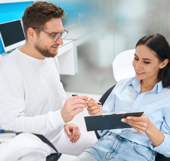 Dental team member assisting patient with insurance paperwork