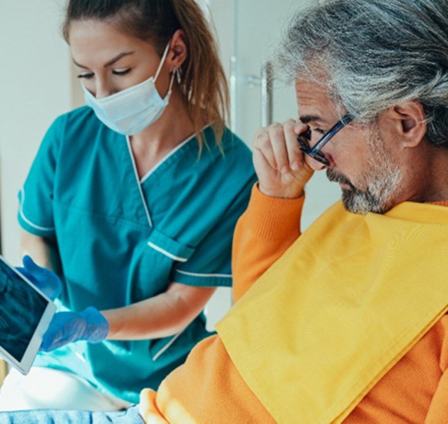 dentist and patient reviewing X-ray   