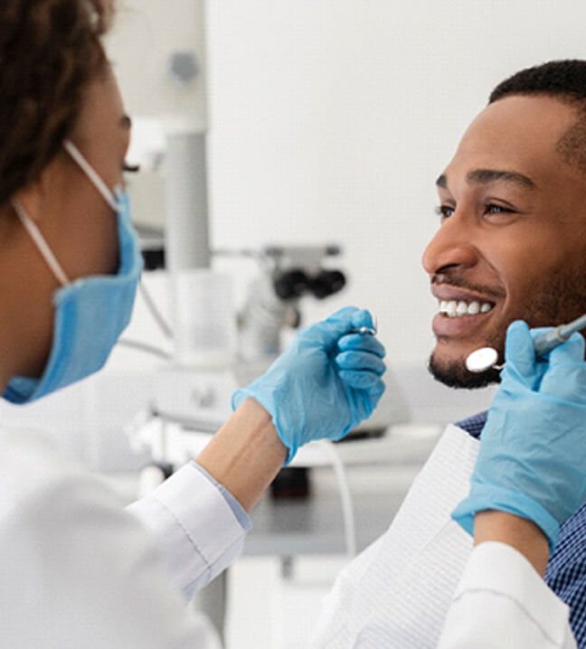 man getting a dental checkup and cleaning
