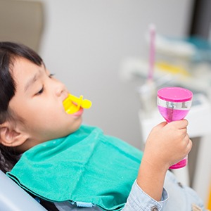 A little girl getting fluoride treatment