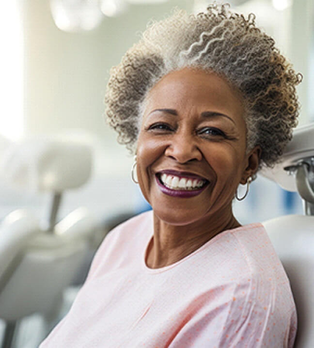 woman smiling in the densit chair