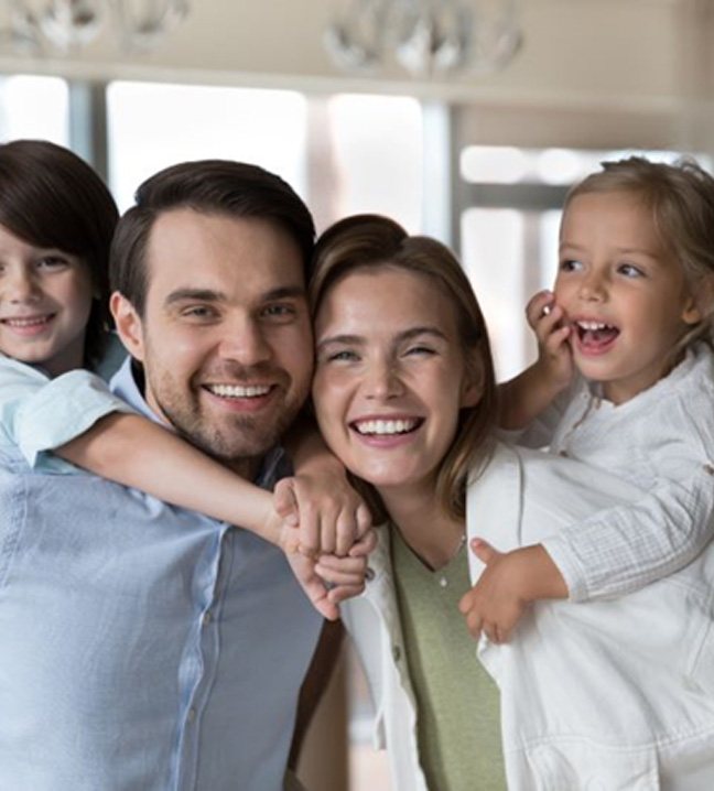 Smiling family with two young children