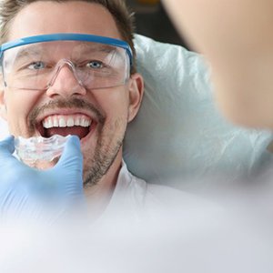 Man getting fitted for custom mouthguard