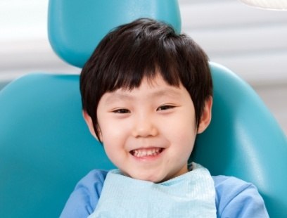 Child smiling during children's dentistry visit