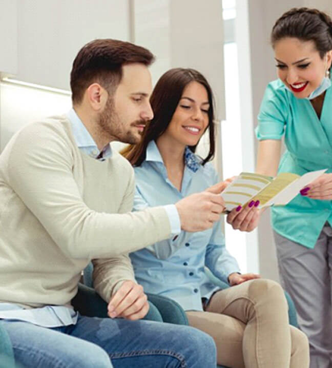 dental patient speaking with a front desk member