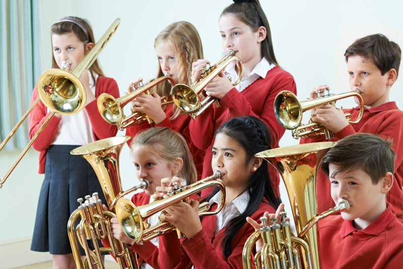 Children playing brass band instruments