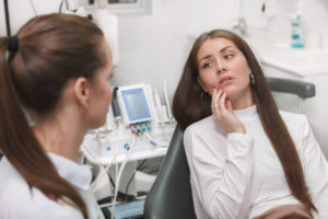 Woman in pain at emergency dentist