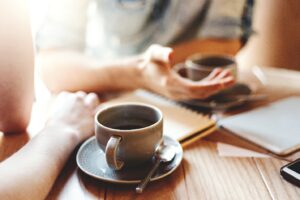 people drinking cups of coffee
